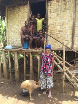 A family of rainforest landowners from Numba, with their house and a pet cassowary