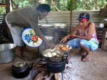 Dolly and Mary frying flourballs, a local delicacy.