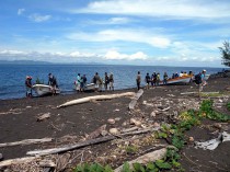 Arriving on the black volcanic beach of Manam.